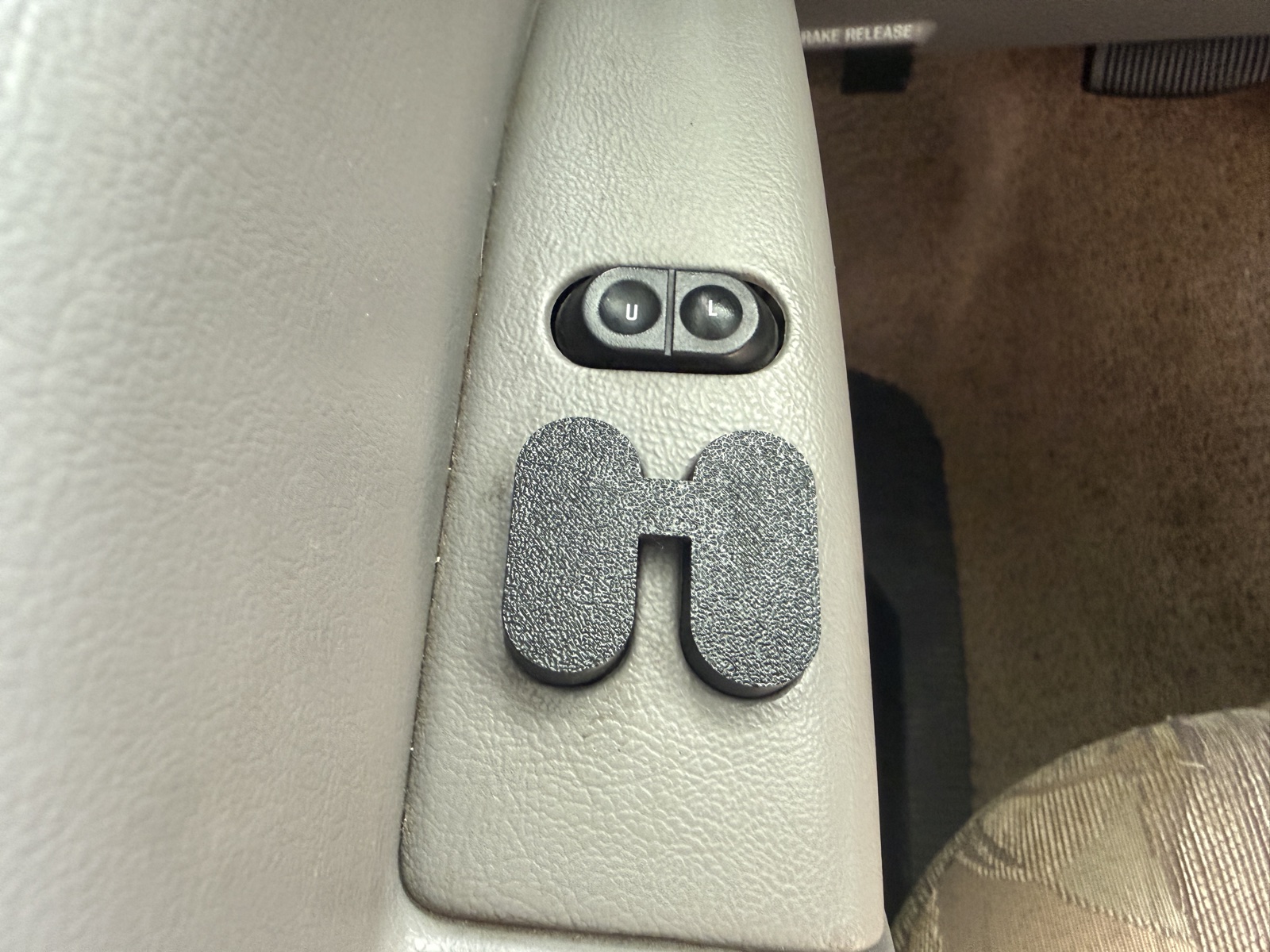Double side-by-side switch cover installed below the door-lock buttons