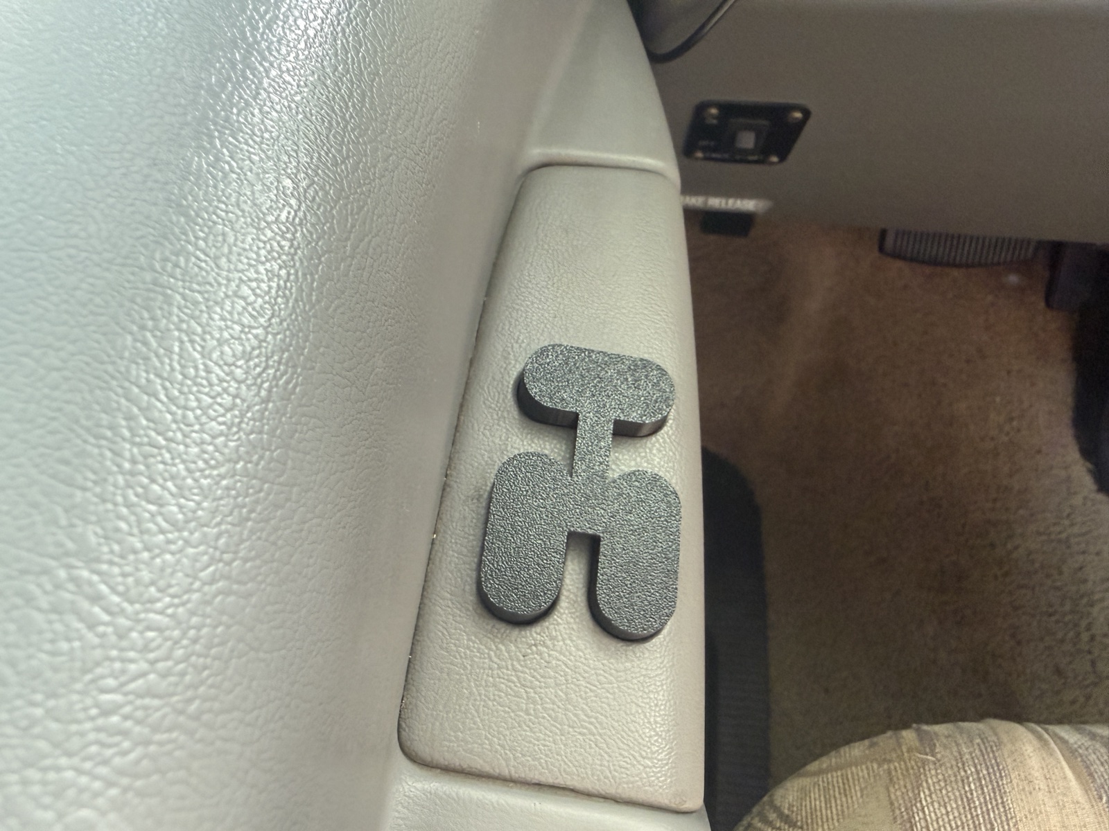 Triple driver-side switch cover installed over the driver-side window and lock cluster