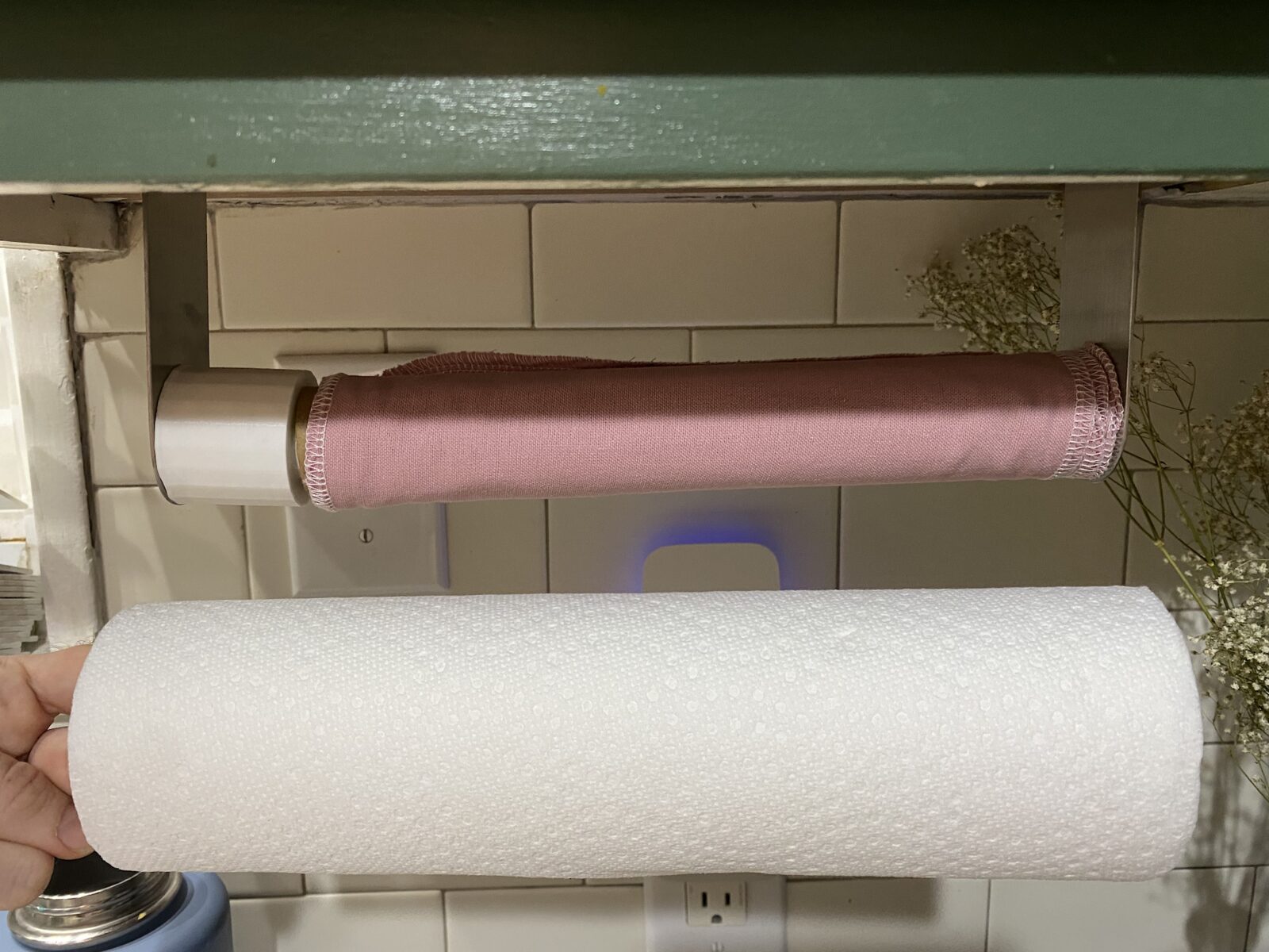 Paper towel roll adapter installed on a holder fitting a smaller roll